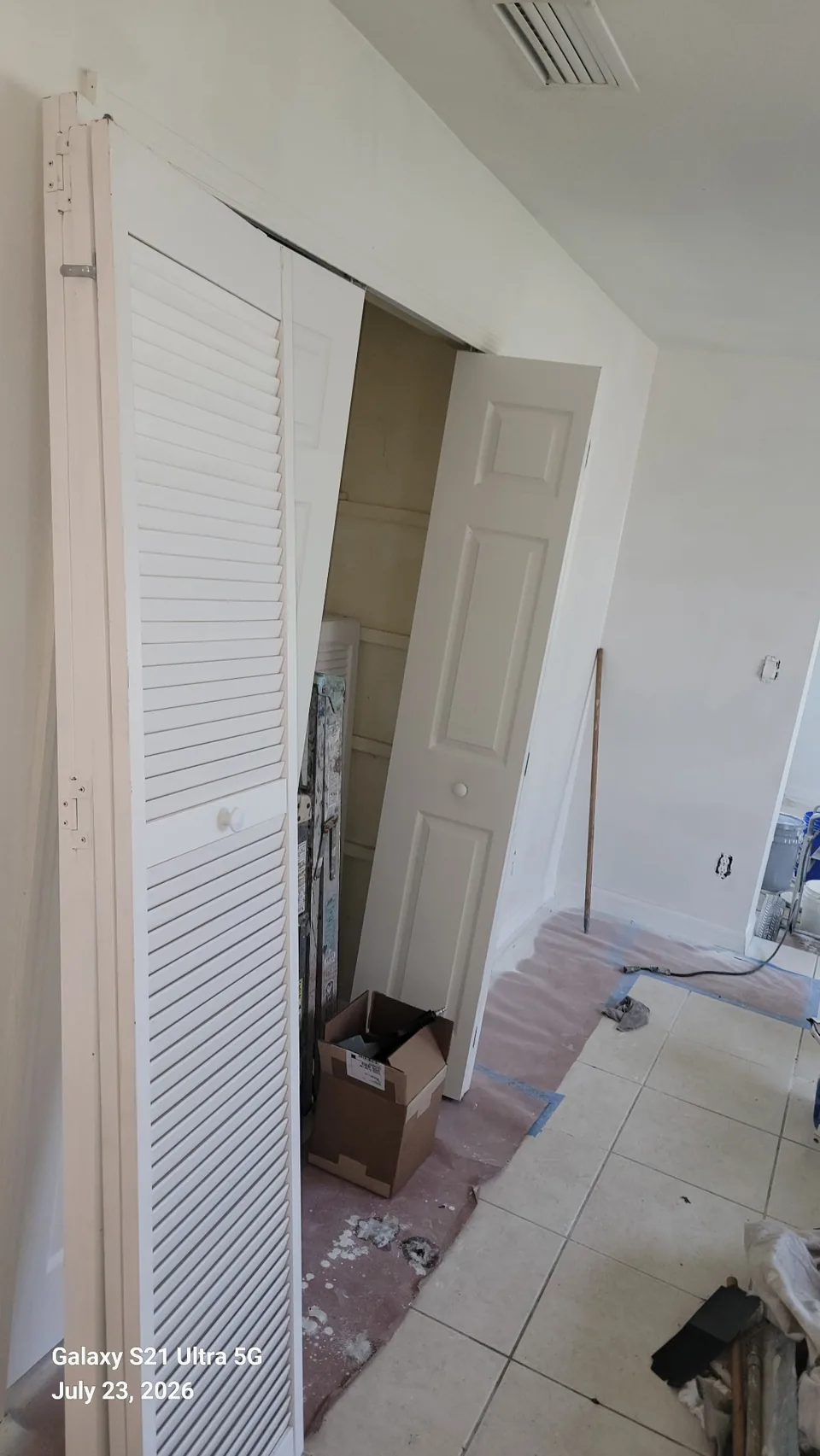 Interior hallway and louvered closet doors prepped for painting in Brevard County, FL