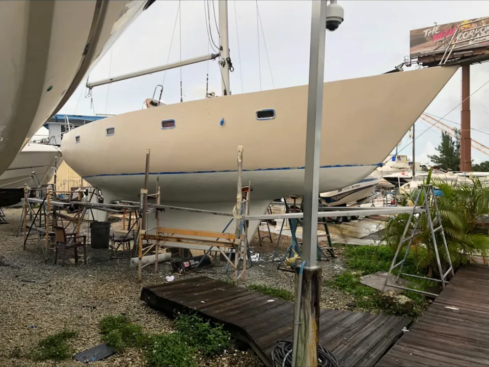 Sailboat hull repainted in cream topside finish on boat stands in Brevard County, FL