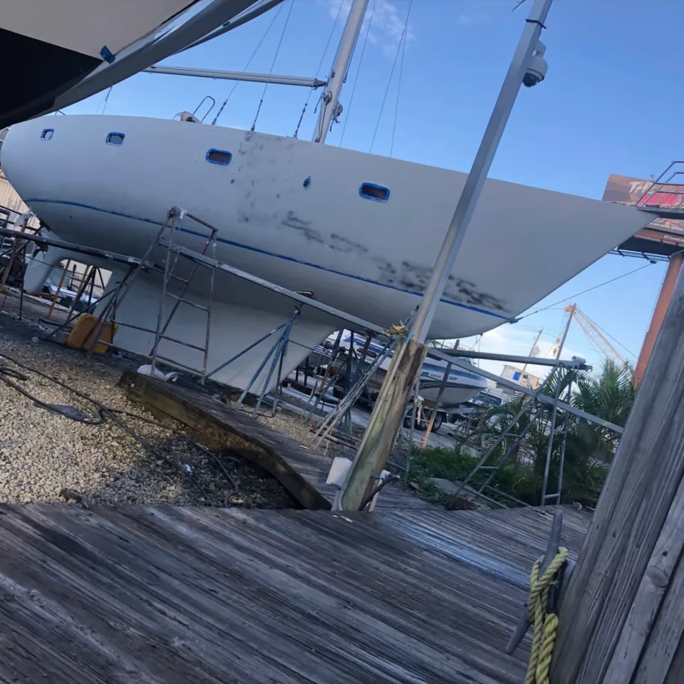 Sailboat hull sanded and spot-primed during marine painting prep in Brevard County, FL