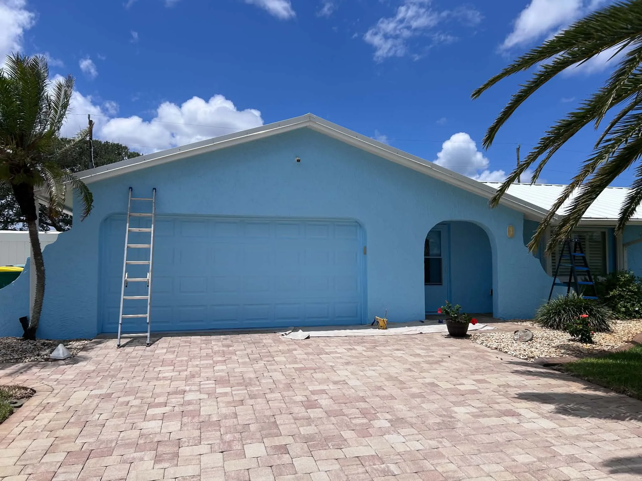 Freshly repainted blue home exterior in Brevard County FL by Paint Craft of Brevard
