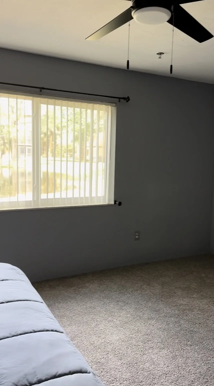 Interior painting in Titusville, FL — bedroom with modern gray walls