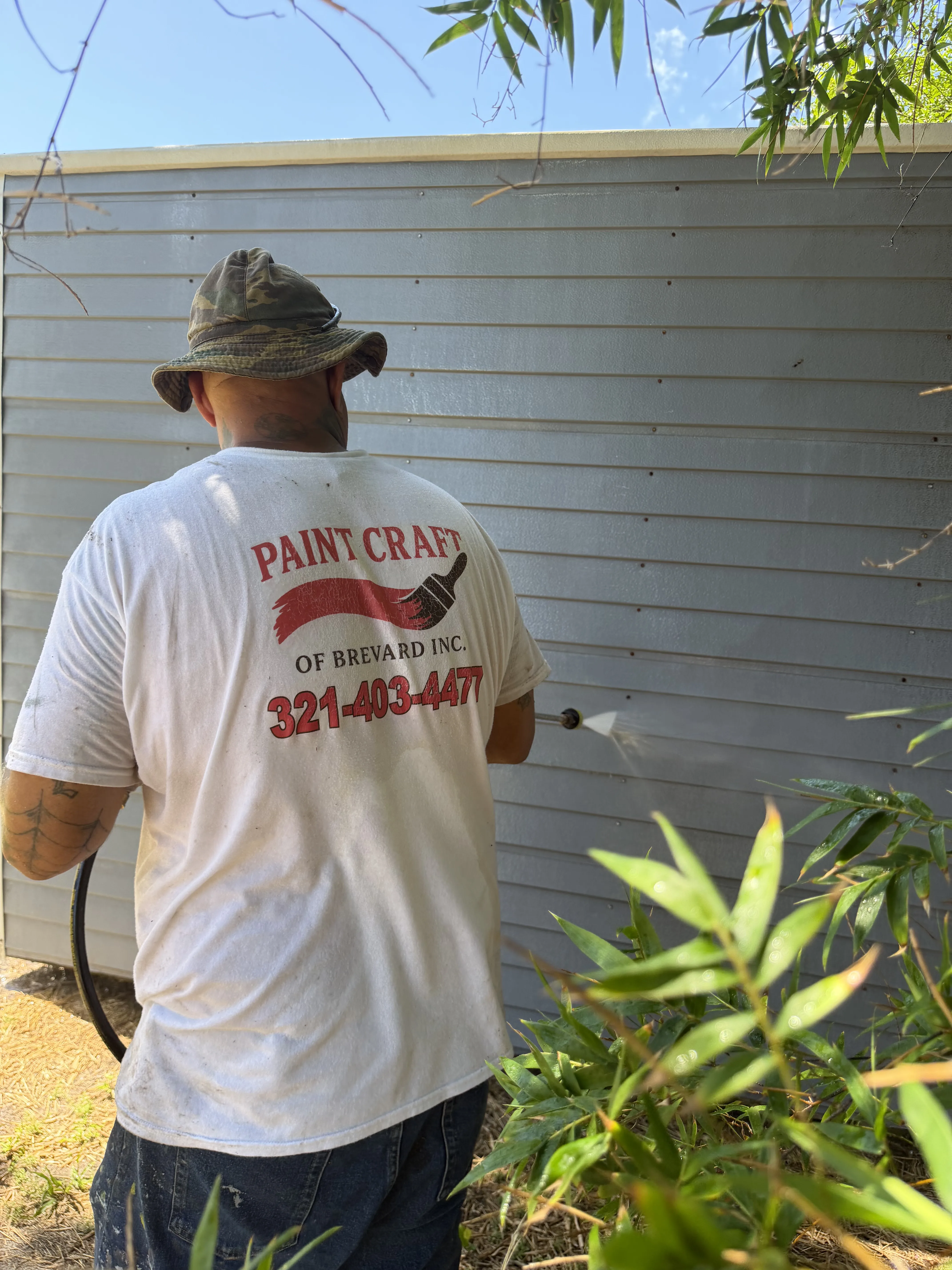 Pressure washing exterior siding to prep for painting in Brevard County, FL by Paint Craft of Brevard